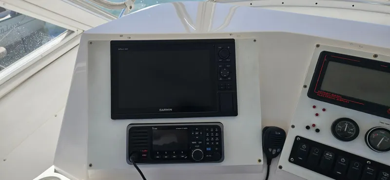 True Grit Yacht Photos Pics 1995 Bertram Convertible boat dashboard with navigation and communication equipment.