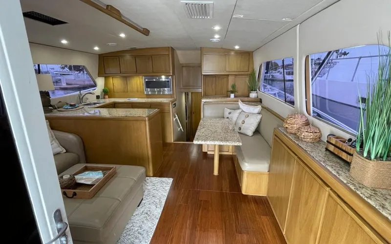 True Grit Yacht Photos Pics Luxurious interior of a 1995 Bertram Convertible yacht with modern kitchen and seating area.