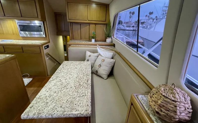 True Grit Yacht Photos Pics Interior of a 1995 Bertram Convertible yacht with granite table and cozy seating.