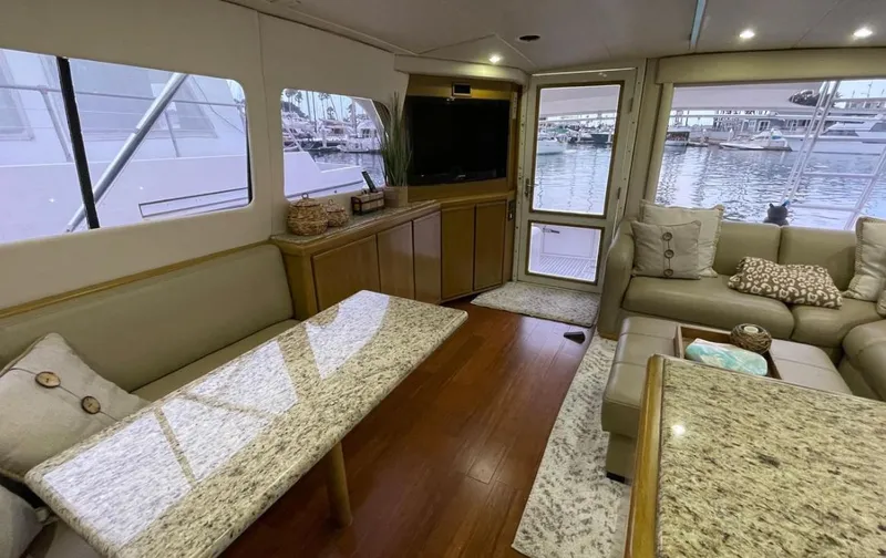 True Grit Yacht Photos Pics Luxurious interior of a 1995 Bertram Convertible yacht with elegant seating and waterfront view.