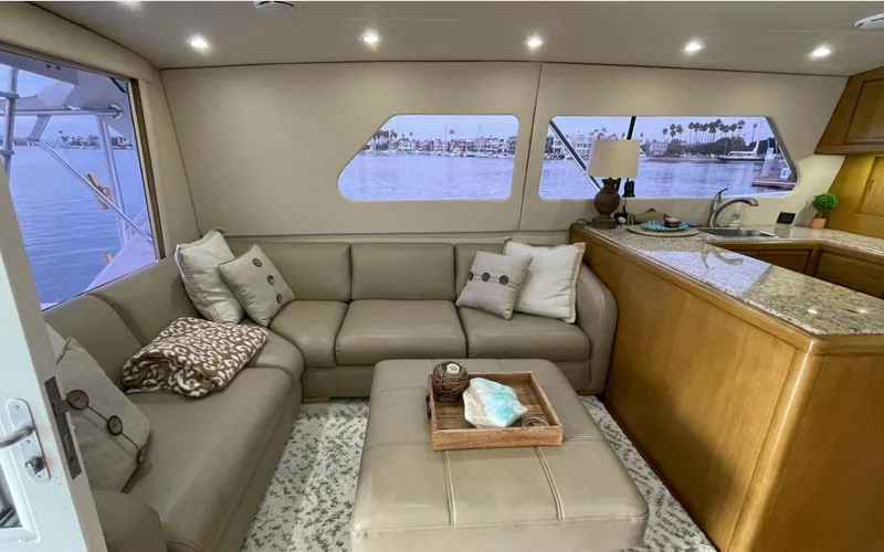 True Grit Yacht Photos Pics Luxurious interior of a 1995 Bertram Convertible yacht with plush seating and elegant decor.