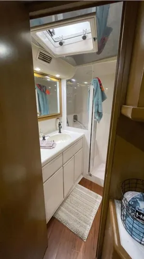 True Grit Yacht Photos Pics Bathroom interior of a 1995 Bertram Convertible yacht with shower and vanity.