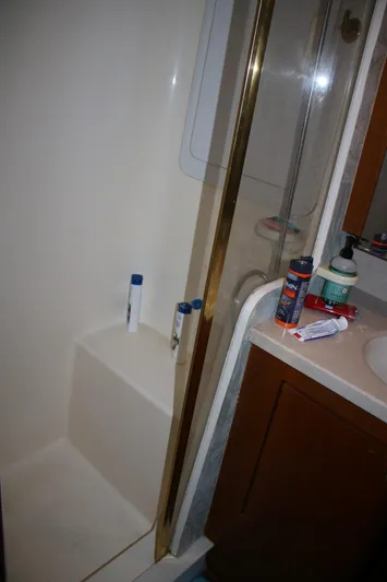 Sweetemocian Yacht Photos Pics Bathroom interior of a 1999 Ocean Yachts model, featuring a shower and sink area.