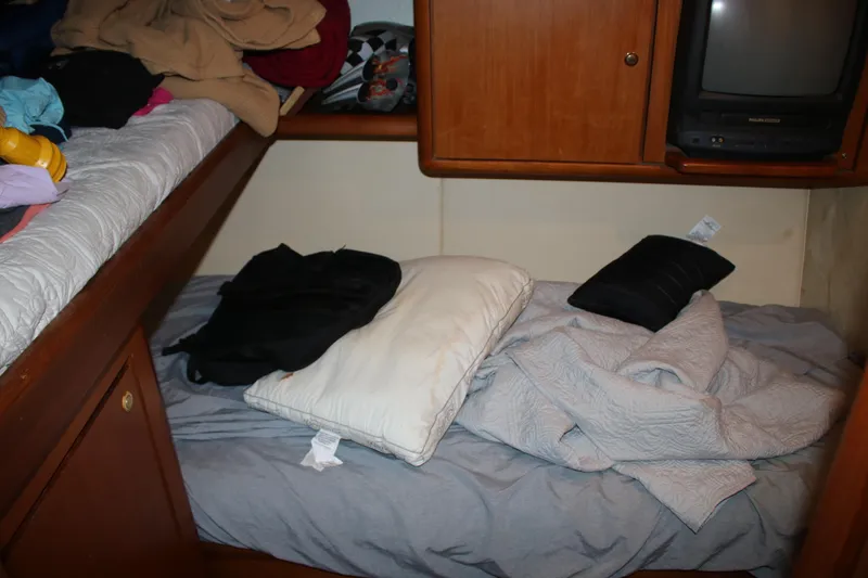 Sweetemocian Yacht Photos Pics Cozy cabin interior of a 1999 Ocean Yachts model, featuring a bed and storage.