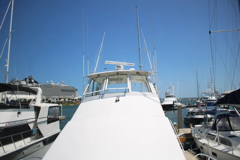 Sweetemocian Yacht Photos Pics 1999 Ocean Yachts model docked in a marina, surrounded by other boats under a clear blue sky.