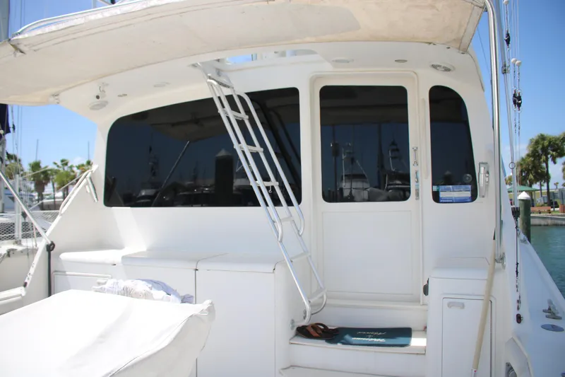 Sweetemocian Yacht Photos Pics 1999 Ocean Yachts model yacht with white exterior and ladder, docked at a marina.