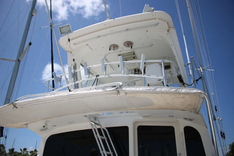 Sweetemocian Yacht Photos Pics 1999 Ocean Yachts model, white yacht exterior with upper deck, clear blue sky background.