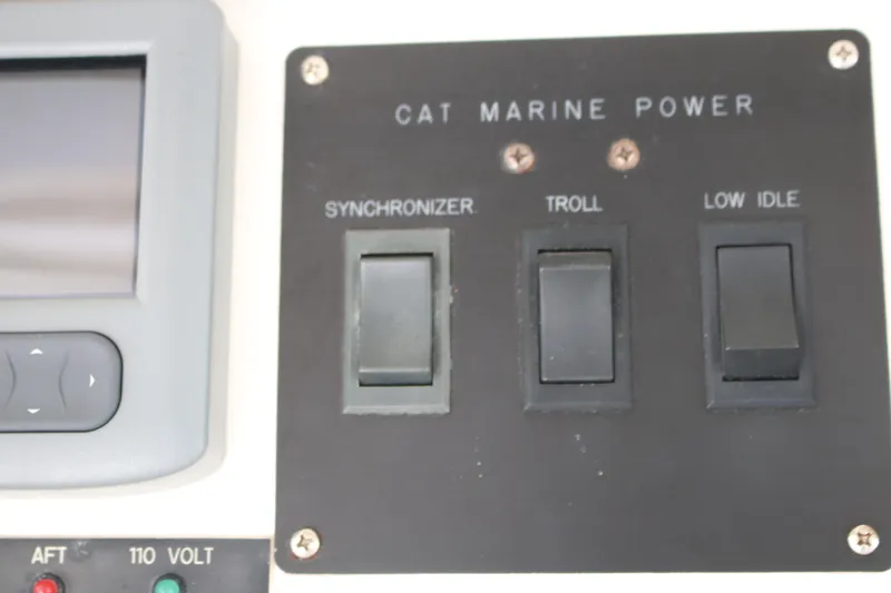 Sweetemocian Yacht Photos Pics Control panel of a 1999 Ocean Yachts featuring CAT Marine Power switches.