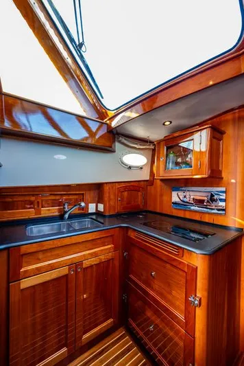 Virginia Yacht Photos Pics 2013 Hinckley Talaria 48 Flybridge yacht kitchen with wood cabinetry and modern amenities.