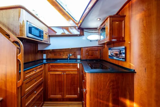 Virginia Yacht Photos Pics Luxurious wooden interior of 2013 Hinckley Talaria 48 Flybridge yacht kitchen.