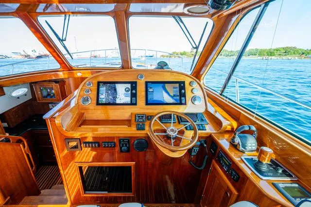 Virginia Yacht Photos Pics Helm of 2013 Hinckley Talaria 48 Flybridge with wooden finish and navigation screens.