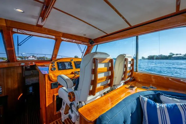 Virginia Yacht Photos Pics Interior of 2013 Hinckley Talaria 48 Flybridge yacht with wooden helm and plush seating.