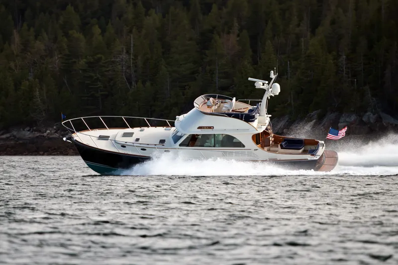 Virginia Yacht Photos Pics 2013 Hinckley Talaria 48 Flybridge cruising on water with forested shoreline in background.