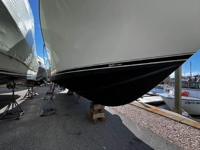  Yacht Photos Pics 2002 Carolina Classic 35 boat hull on stands, marina background.