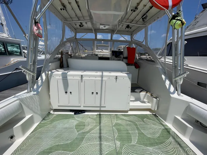  Yacht Photos Pics 2002 Carolina Classic 35 boat interior with fishing gear and green patterned mat.