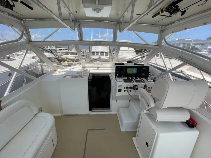  Yacht Photos Pics 2002 Carolina Classic 35 boat interior with helm, seating, and navigation equipment.