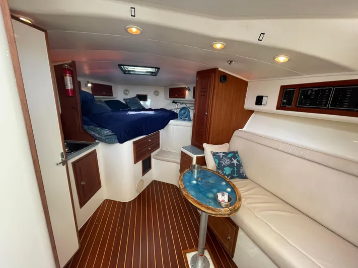  Yacht Photos Pics Interior of 2002 Carolina Classic 35 boat with cozy seating and wooden accents.
