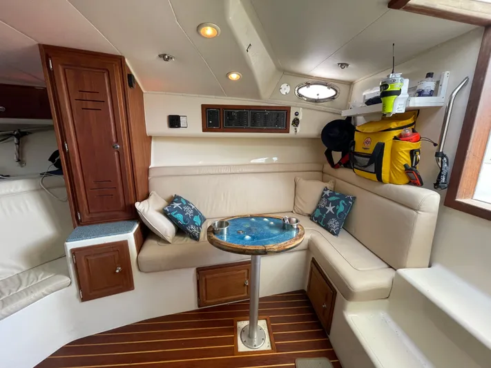  Yacht Photos Pics 2002 Carolina Classic 35 interior with cozy seating, wooden accents, and nautical decor.