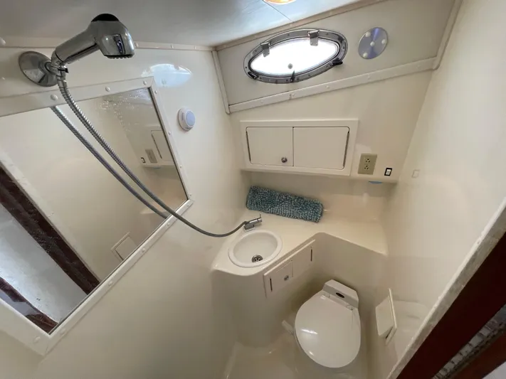  Yacht Photos Pics Compact bathroom in 2002 Carolina Classic 35 boat with shower, sink, and toilet.