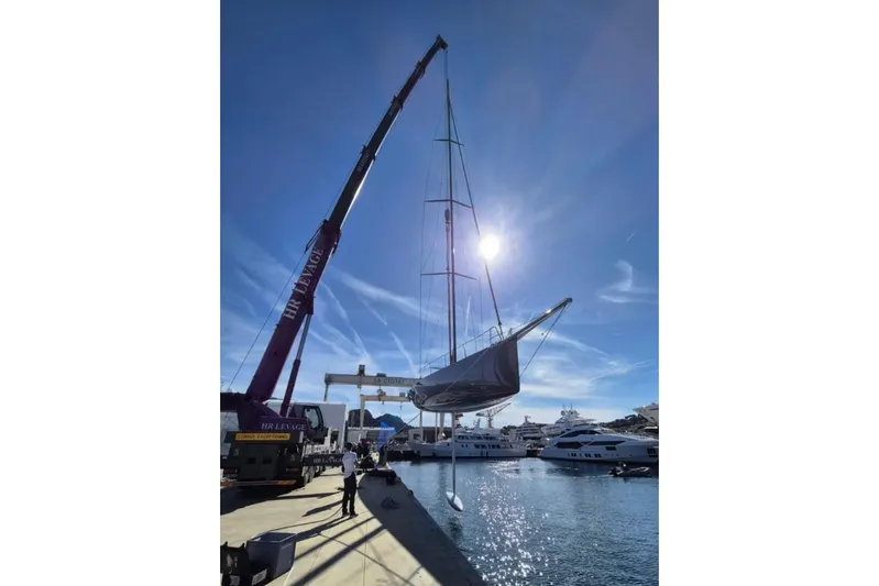 North Star Yacht Photos Pics Crane lifting 2009 Judel and Vrolijk Maxi 72 yacht at marina under clear sky.