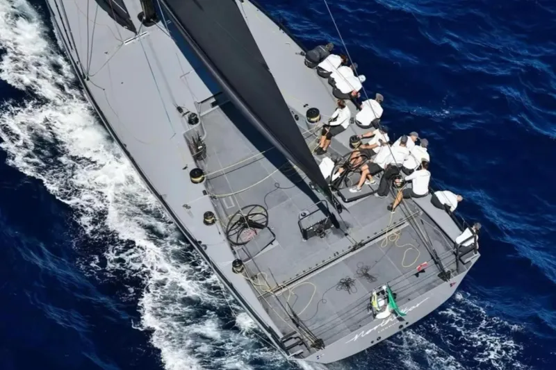 North Star Yacht Photos Pics Aerial view of 2009 Judel and Vrolijk Maxi 72 yacht sailing with crew on blue ocean.