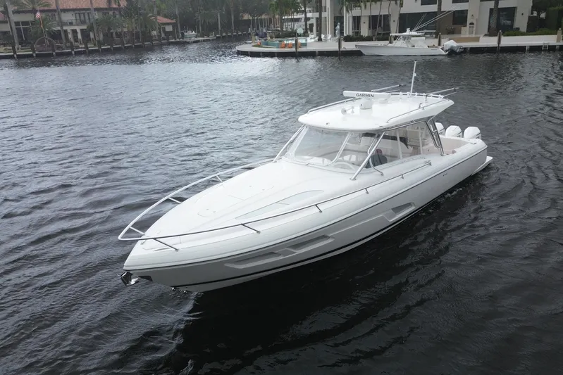 Day Dreams Yacht Photos Pics 2021 Intrepid 409 Valor boat on calm water near waterfront homes.