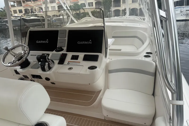 Day Dreams Yacht Photos Pics 2021 Intrepid 409 Valor boat interior with Garmin navigation system and luxurious seating.