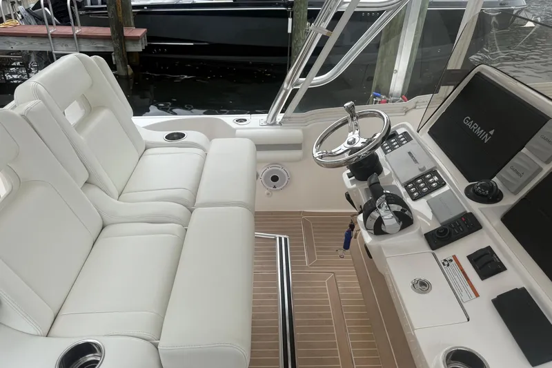 Day Dreams Yacht Photos Pics 2021 Intrepid 409 Valor boat interior with white seating and Garmin navigation system.