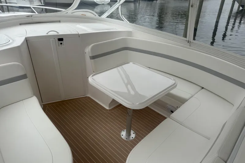 Day Dreams Yacht Photos Pics 2021 Intrepid 409 Valor boat interior with white seating and wooden flooring.