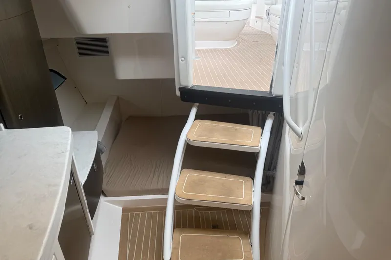 Day Dreams Yacht Photos Pics Interior of 2021 Intrepid 409 Valor boat with wooden steps and cabin area.