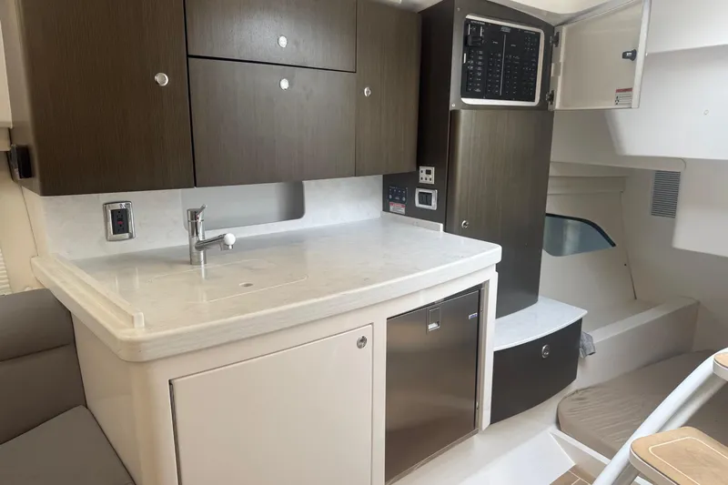 Day Dreams Yacht Photos Pics 2021 Intrepid 409 Valor yacht interior with modern kitchenette and sleek cabinetry.