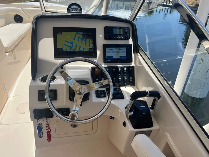 (no Name) Yacht Photos Pics 2019 Grady-White 275 boat helm with steering wheel, navigation screens, and controls.