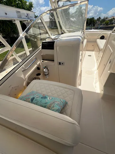 (no Name) Yacht Photos Pics 2019 Grady-White 275 boat interior with cushioned seating and clear windshield.