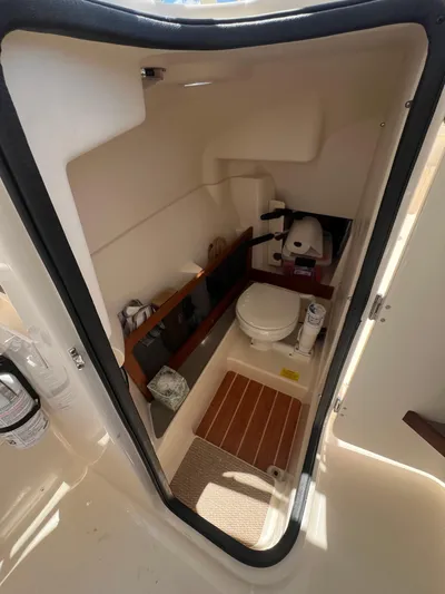 (no Name) Yacht Photos Pics 2019 Grady-White 275 boat interior with compact bathroom and toilet.