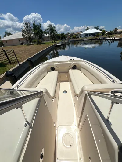(no Name) Yacht Photos Pics 2019 Grady-White 275 boat interior with cushioned seating, docked in a sunny canal.