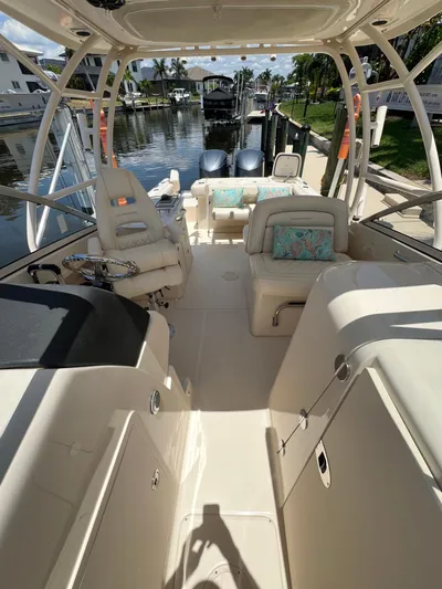 (no Name) Yacht Photos Pics 2019 Grady-White 275 boat interior with seating and helm, docked by a canal.