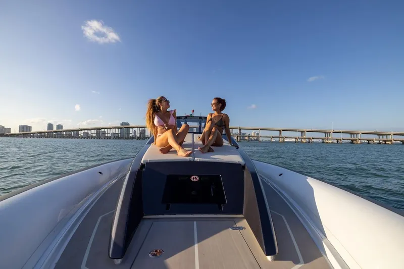  Yacht Photos Pics Two people relaxing on a 2025 Anvera 42 Speedster boat in sunny waters.