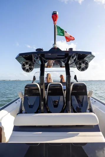  Yacht Photos Pics 2025 Anvera 42 Speedster boat on water, rear view with flag and passengers.