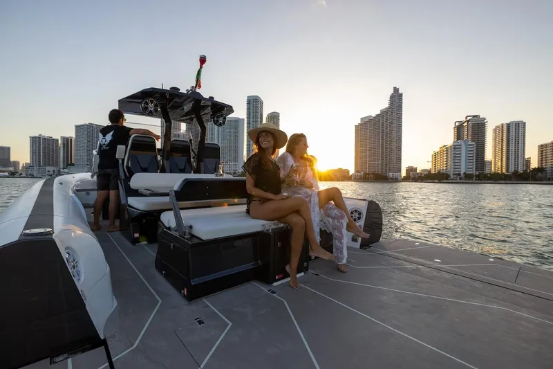  Yacht Photos Pics 2025 Anvera 42 Speedster boat cruising with passengers at sunset near city skyline.