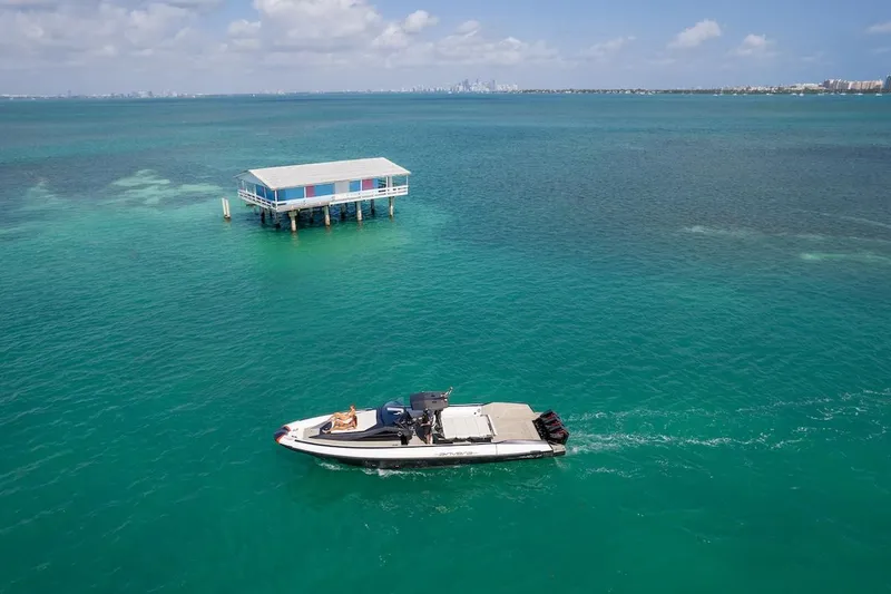  Yacht Photos Pics 2025 Anvera 42 Speedster cruising near a stilt house on turquoise waters.