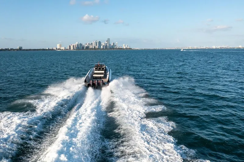  Yacht Photos Pics 2025 Anvera 42 Speedster cruising on open water with city skyline in background.
