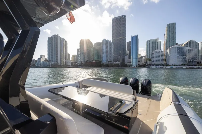  Yacht Photos Pics 2025 Anvera 42 Speedster yacht cruising near city skyline at sunset.
