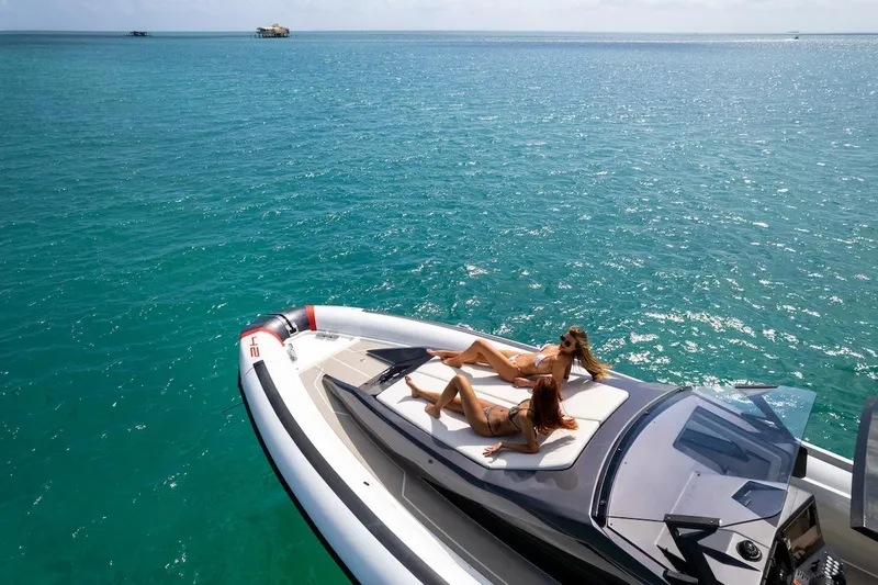  Yacht Photos Pics 2025 Anvera 42 Speedster yacht with two people relaxing on deck in clear blue waters.