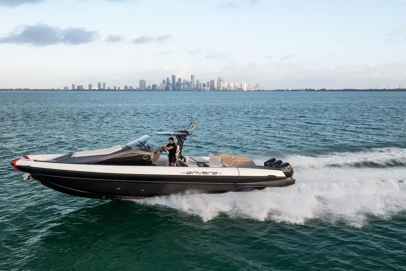  Yacht Photos Pics 2025 Anvera 42 Speedster cruising on ocean with city skyline in background.