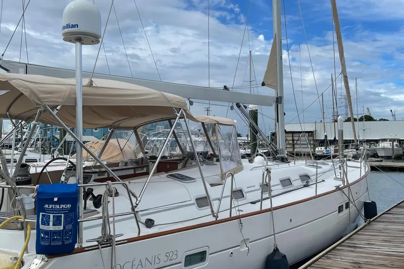 Gitana Yacht Photos Pics 2006 Beneteau Oceanis 523 sailboat docked at marina under cloudy sky.