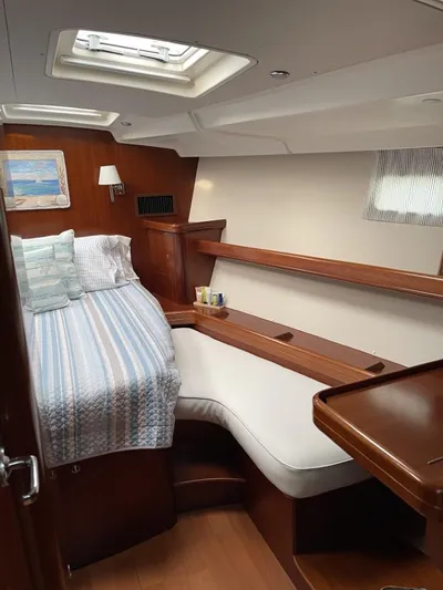 Gitana Yacht Photos Pics Luxurious cabin interior of 2006 Beneteau Oceanis 523 yacht with cozy bed and seating.
