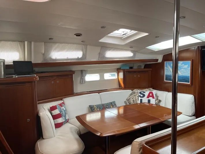 Gitana Yacht Photos Pics Interior of 2006 Beneteau Oceanis 523 yacht with elegant wood finish and cozy seating area.