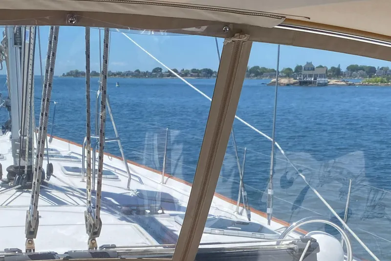 Gitana Yacht Photos Pics Sailing on a 2006 Beneteau Oceanis 523, overlooking serene coastal waters.