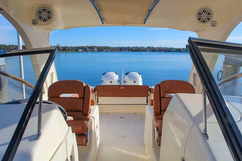 Scout 275 Dorado Yacht Photos Pics 2018 Scout 275 Dorado boat interior with twin engines on a calm lake.