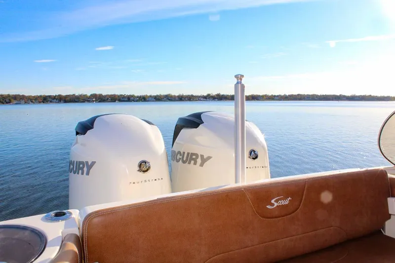 Scout 275 Dorado Yacht Photos Pics 2018 Scout 275 Dorado boat with twin Mercury engines on a calm lake.